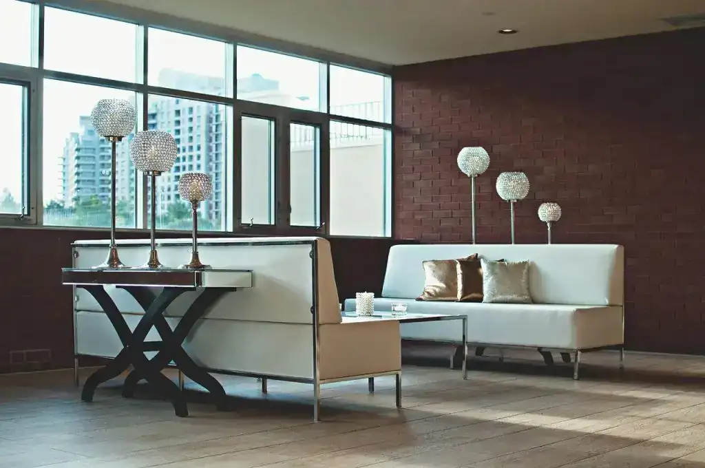 Turnkey Projects Contemporary living room with modern furniture, decorative lamps, and large windows showcasing cityscape.